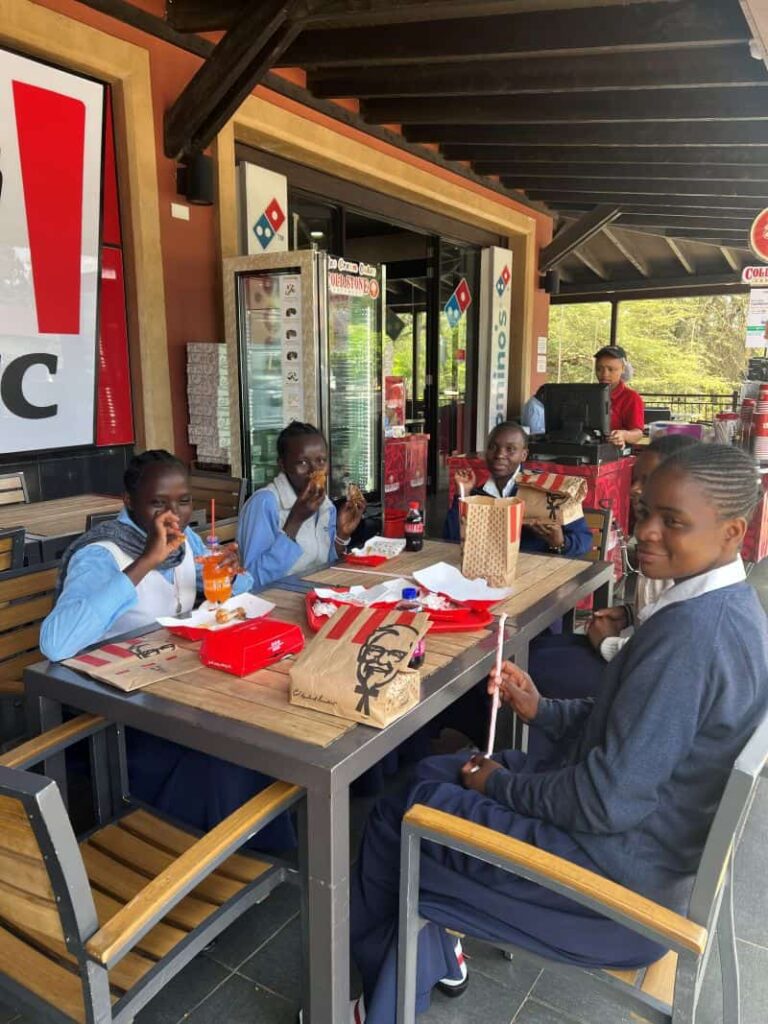 sisters sitting around a table eating Kentucky Fried Chicken