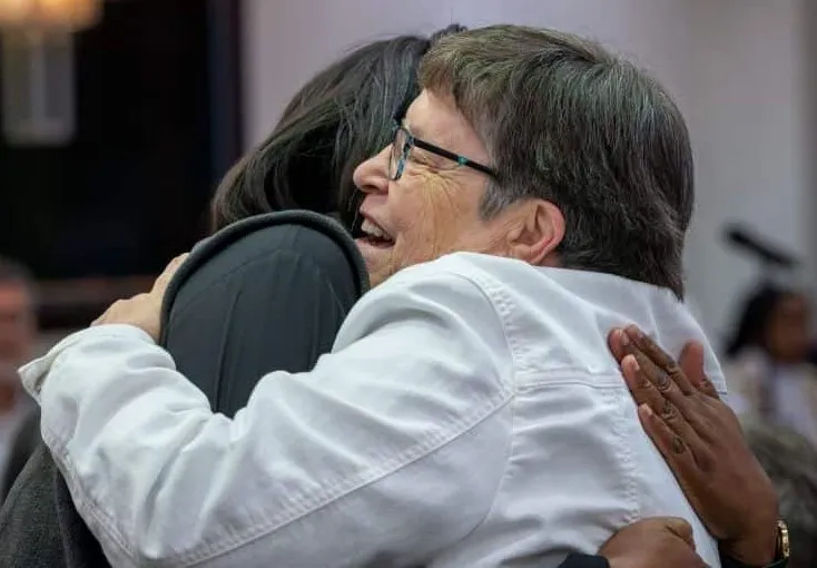 Sister hugging a partner-in-mission at a gathering.