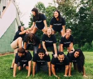 The 2026 Good Shepherd Volunteers building a human pyramid.