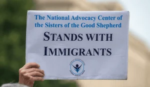 A NAC sign that says, "NAC stands with immigrants."