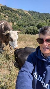 Sr. Madeleine featured with two cows at a rescue ranch.