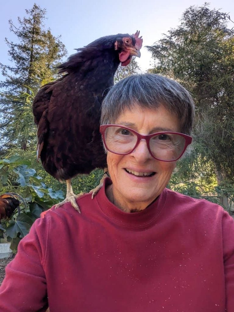 Sr. Madeleine Munday takes a selfie with a rooster at OLS. 