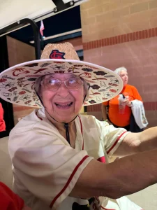 Sr. Rose Kern wearing her Cardinal's hat at the baseball game.