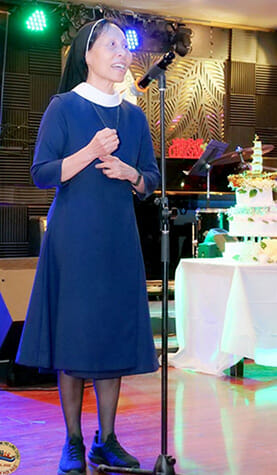 Sister Christine speaking at reunion